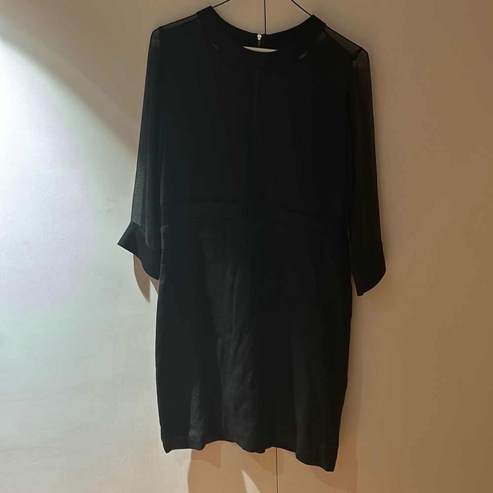 Black mini dress with sheer sleeves and details on top